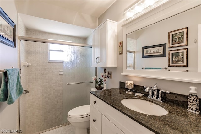 bathroom with tile floors, oversized vanity, and toilet