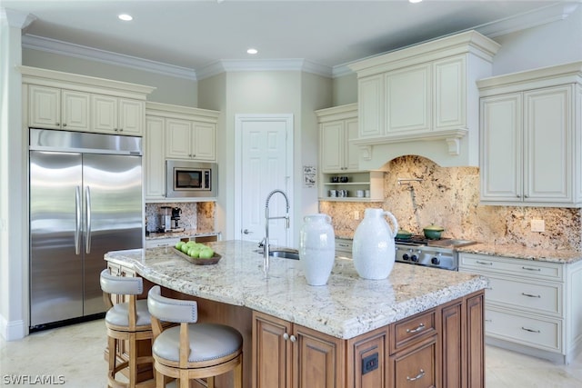 kitchen with built in appliances, light stone counters, a sink, and crown molding