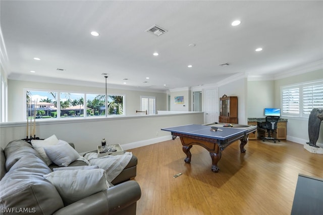 playroom with light wood-style floors, visible vents, crown molding, and baseboards