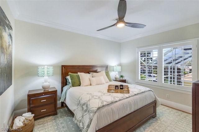 bedroom featuring ornamental molding, ceiling fan, and baseboards