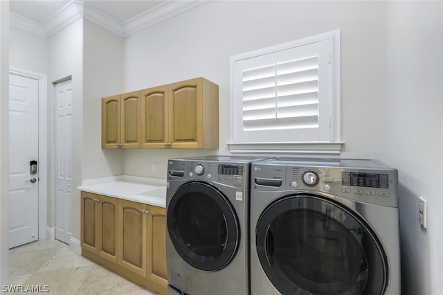 washroom with cabinet space, separate washer and dryer, and crown molding