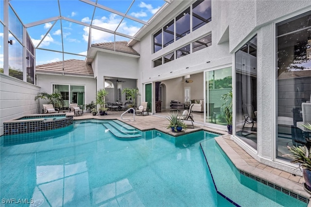 view of swimming pool with a pool with connected hot tub, a patio, a lanai, and ceiling fan