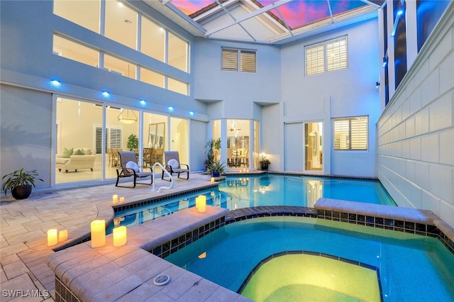 view of swimming pool featuring a pool with connected hot tub and a patio