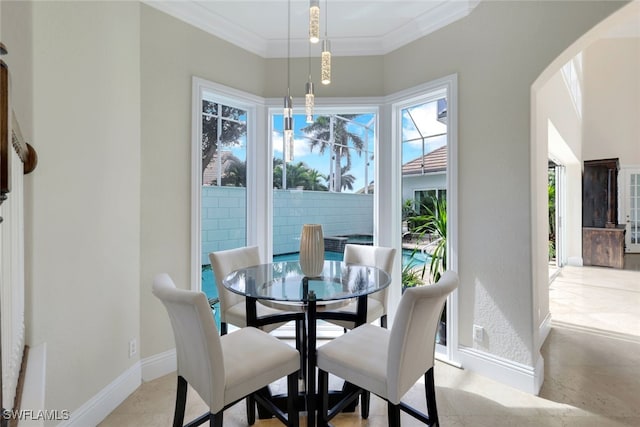 dining space featuring baseboards and ornamental molding