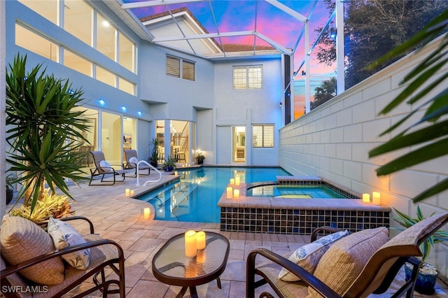 view of swimming pool with a pool with connected hot tub, a lanai, and a patio