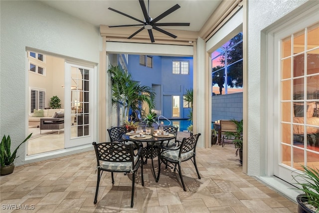 sunroom / solarium with a ceiling fan