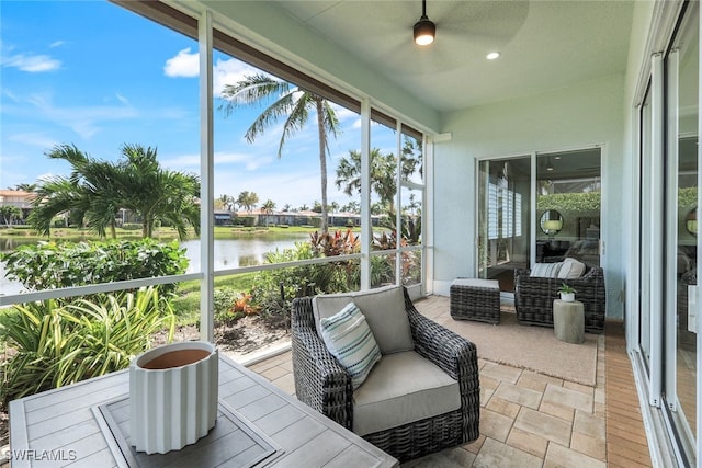 sunroom / solarium featuring a water view