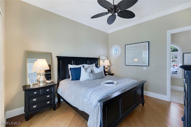 bedroom with baseboards, ornamental molding, and light wood-style floors