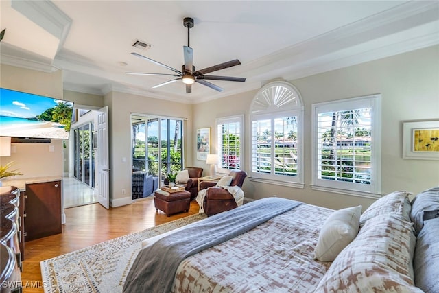 bedroom featuring wood finished floors, visible vents, baseboards, access to outside, and ornamental molding