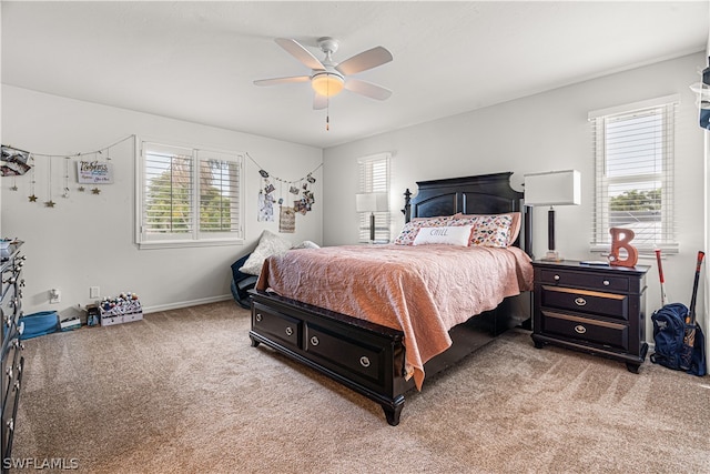 carpeted bedroom featuring ceiling fan and multiple windows