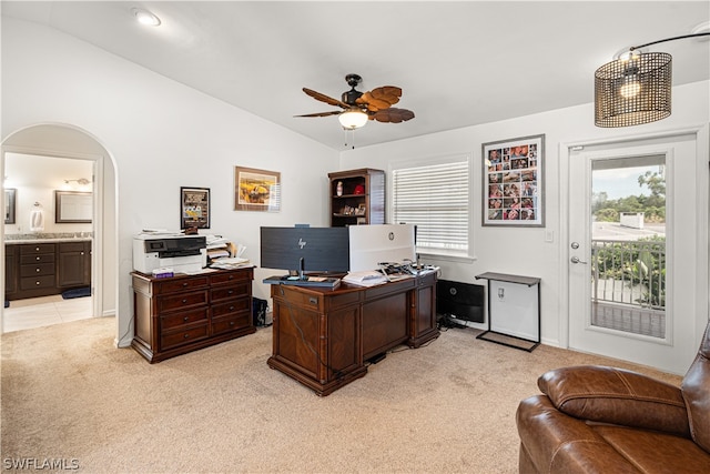 office featuring light carpet, vaulted ceiling, and ceiling fan