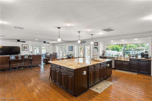 kitchen featuring ceiling fan, pendant lighting, a healthy amount of sunlight, and french doors