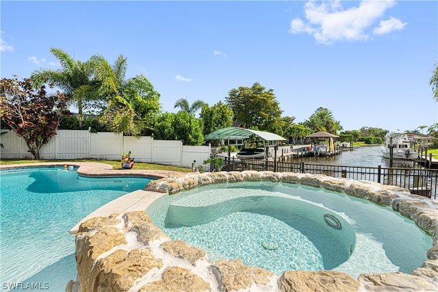 view of pool featuring an in ground hot tub