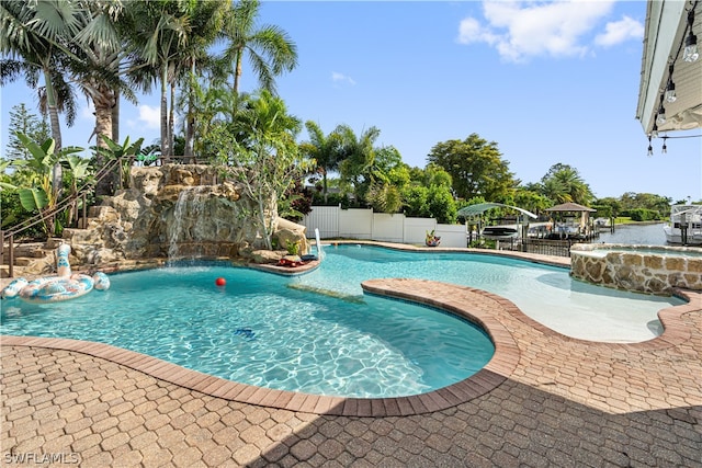 view of swimming pool featuring a gazebo and pool water feature