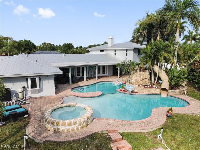 view of pool featuring an in ground hot tub and a patio area