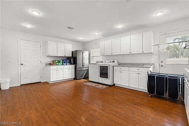 kitchen featuring washer and clothes dryer, white cabinets, dark wood-type flooring, and stainless steel fridge