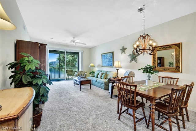 dining room with light carpet and ceiling fan with notable chandelier