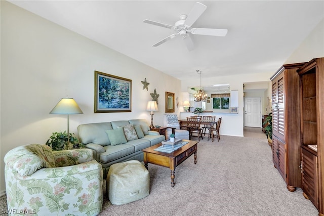 living room with light colored carpet and ceiling fan with notable chandelier