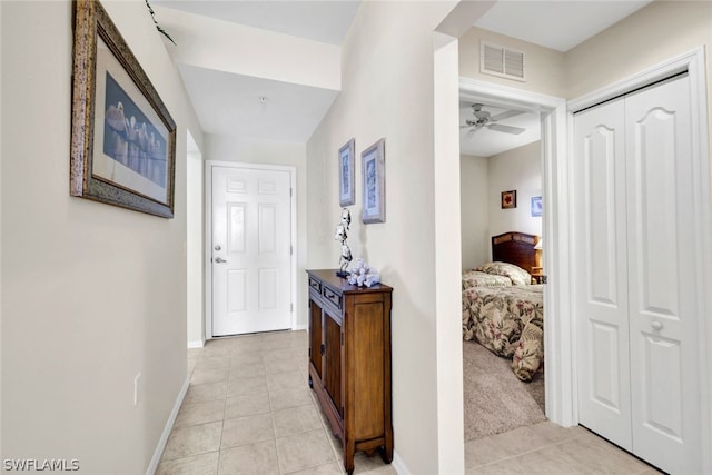 hall featuring light tile flooring