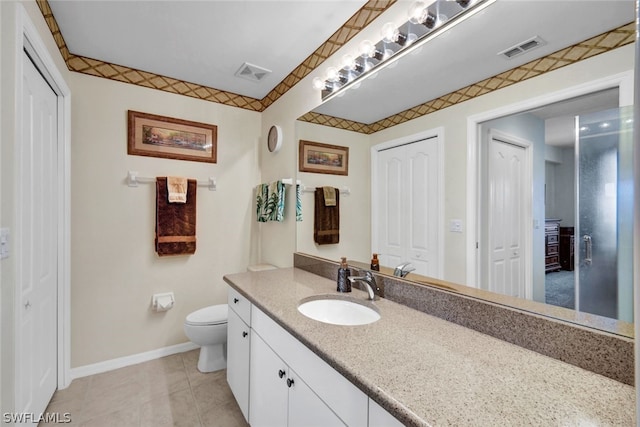 bathroom featuring toilet, tile flooring, and vanity