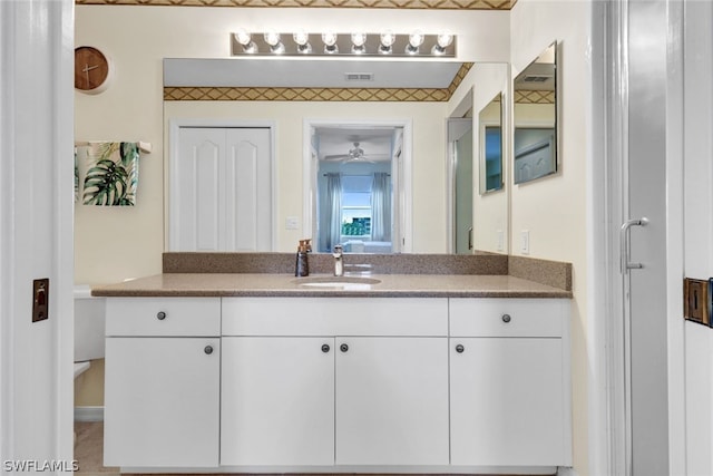 bathroom with toilet and vanity