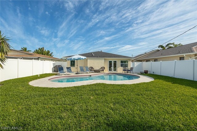 view of pool featuring a lawn