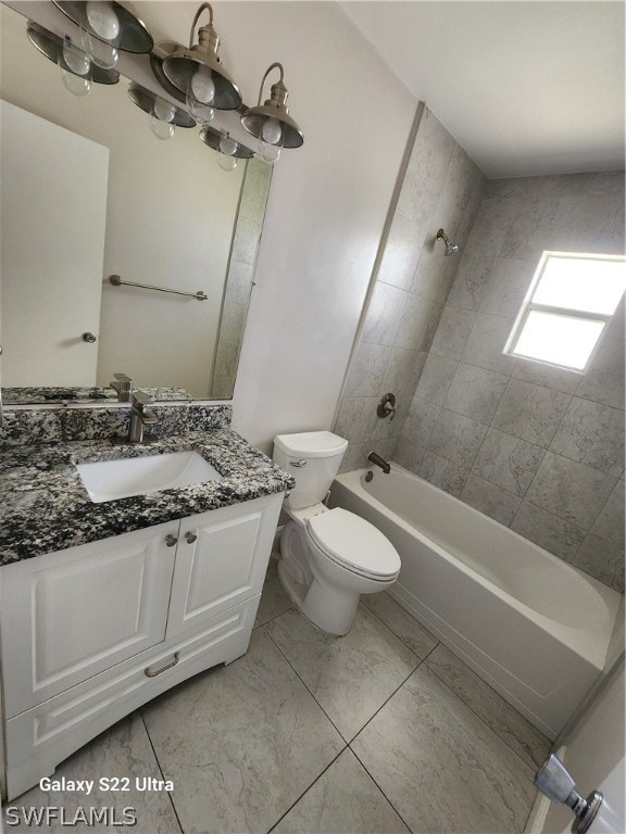 full bathroom featuring tiled shower / bath combo, tile floors, toilet, and vanity