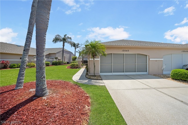 single story home featuring a garage and a front yard