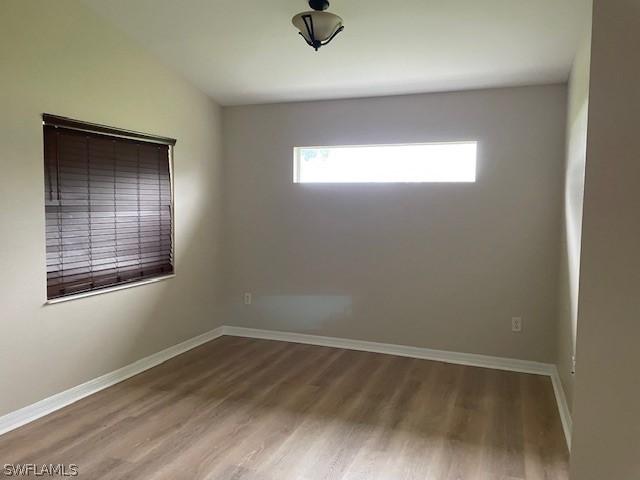 unfurnished room with hardwood / wood-style floors