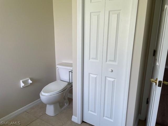 bathroom featuring tile patterned flooring and toilet