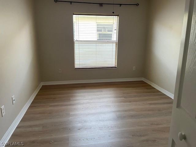 unfurnished room featuring hardwood / wood-style flooring