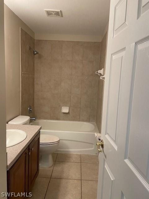 full bathroom featuring tile patterned floors, vanity, toilet, and tiled shower / bath