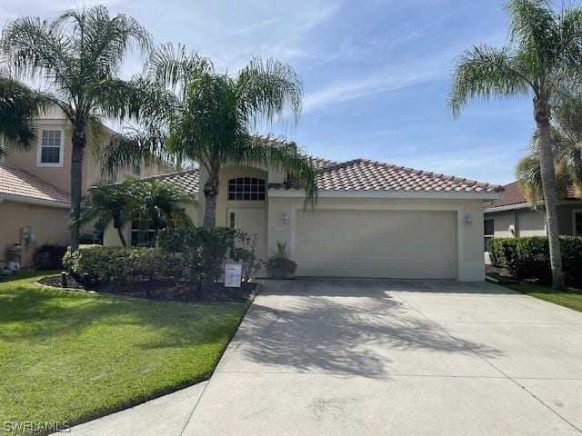 mediterranean / spanish-style home with a garage and a front yard