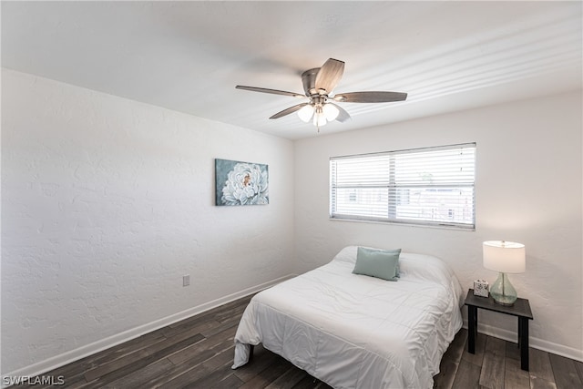 bedroom with ceiling fan and dark hardwood / wood-style floors