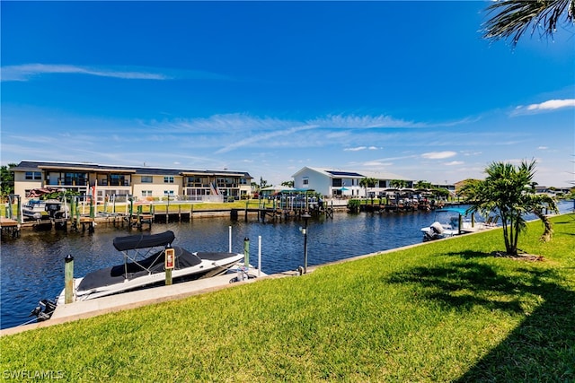 view of dock featuring a yard and a water view