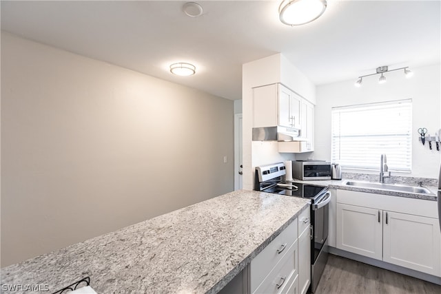 kitchen with light stone counters, white cabinets, sink, light wood-type flooring, and stainless steel electric stove