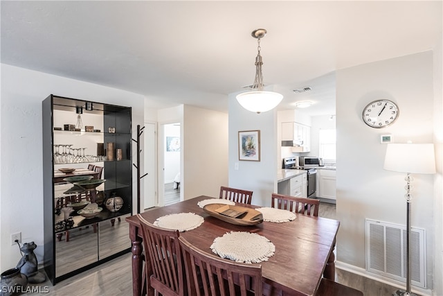 dining room with light hardwood / wood-style floors