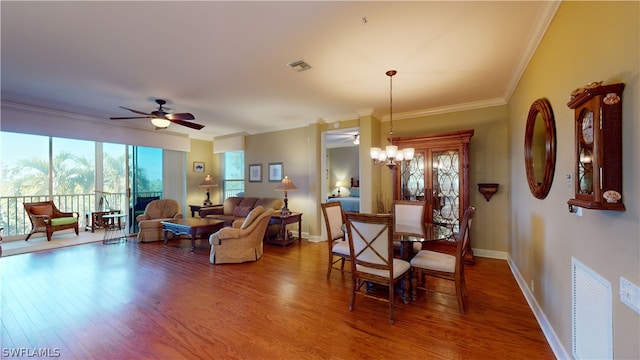 dining space featuring ornamental molding, hardwood / wood-style floors, and ceiling fan with notable chandelier