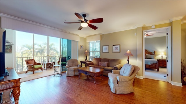 living room featuring ornamental molding, hardwood / wood-style floors, and ceiling fan