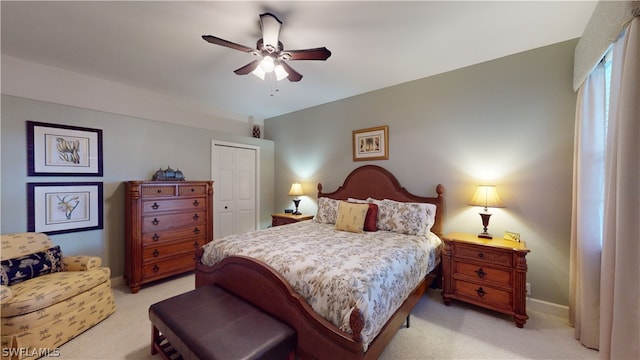 carpeted bedroom featuring a closet and ceiling fan