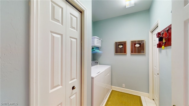 laundry area with light tile patterned flooring and separate washer and dryer