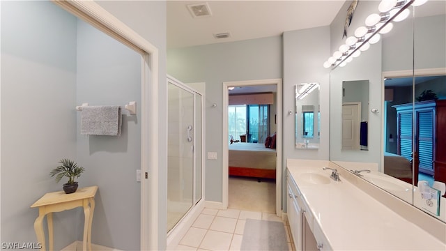 bathroom with vanity, tile patterned flooring, and walk in shower