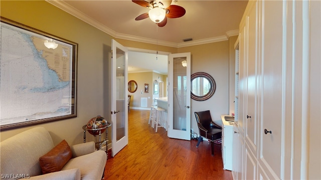 office space featuring crown molding, french doors, wood-type flooring, and ceiling fan