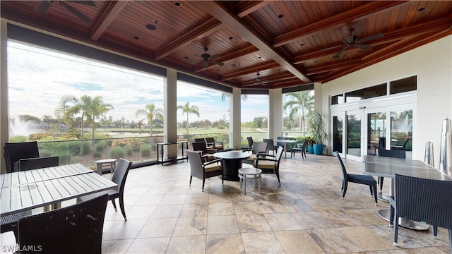 sunroom / solarium featuring beam ceiling, french doors, ceiling fan, and wooden ceiling