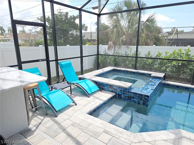 view of pool with a fenced backyard, a patio area, and glass enclosure
