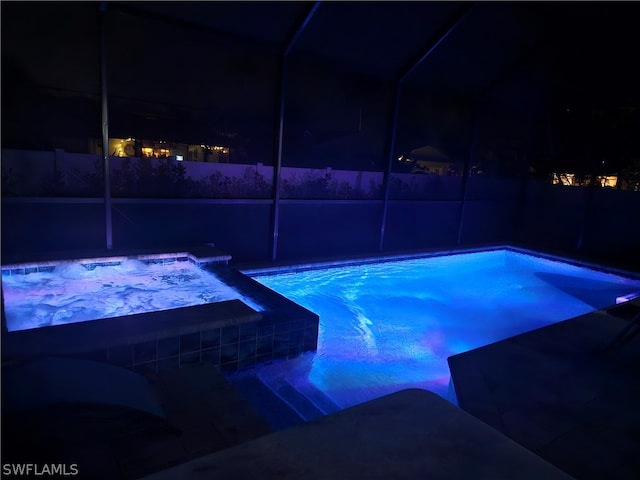 pool at twilight featuring a fenced in pool and glass enclosure