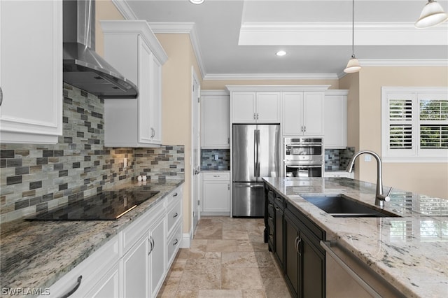 kitchen featuring stainless steel appliances, white cabinetry, wall chimney exhaust hood, and sink