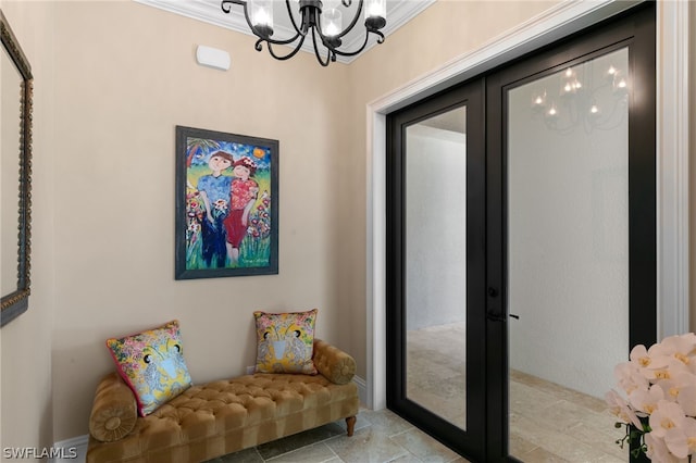 sitting room featuring french doors, a chandelier, and ornamental molding