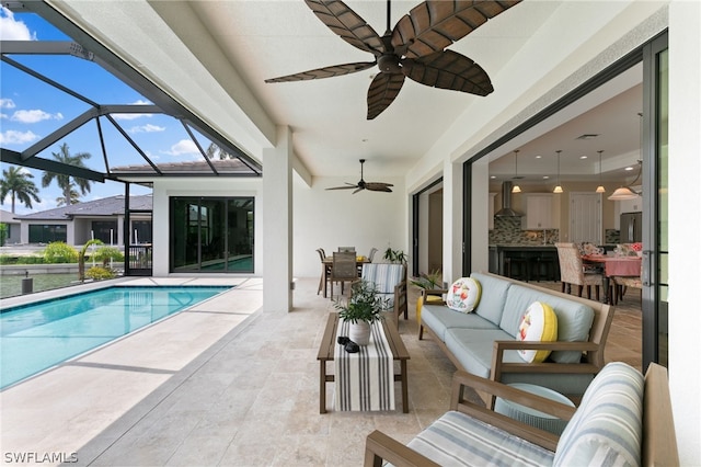 view of pool with a lanai, a patio area, and an outdoor living space