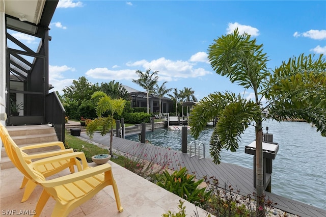 exterior space featuring a water view, a dock, and glass enclosure